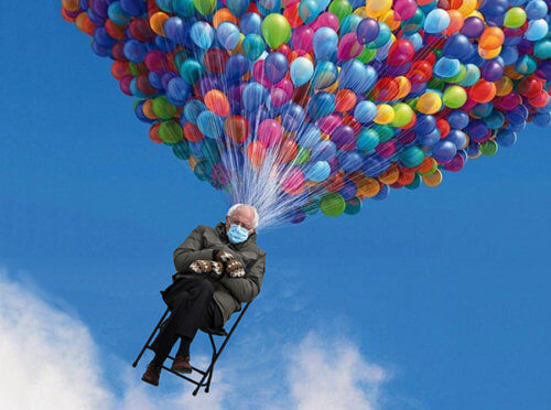 photo of Bernie Sanders wearing mittens seated in chair being lifted up into blue sky by huge multicolored bunch of balloons