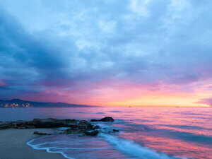 photo of a beach at sunrise